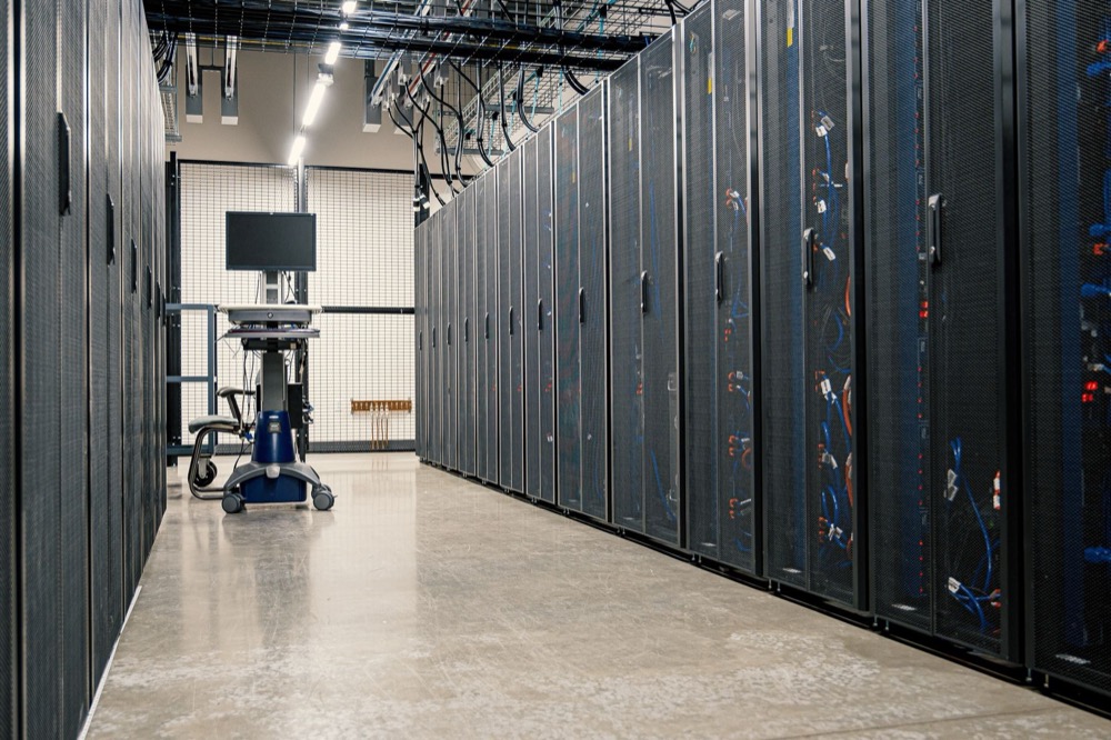 An aisle of server racks in a data centre.